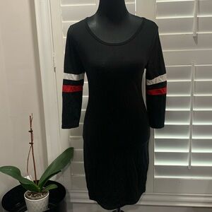 Heart and Hips Black mini dress with red and black strip on sleeve. Size L